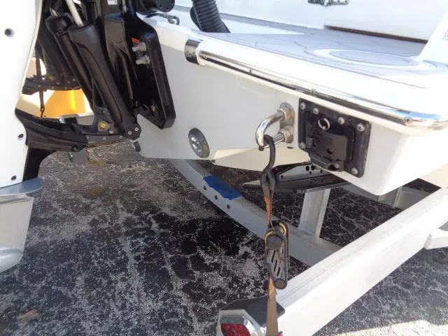  Yacht Photos Pics 2022 Contender 32 ST boat on trailer, showing engine mount and tie-down strap.