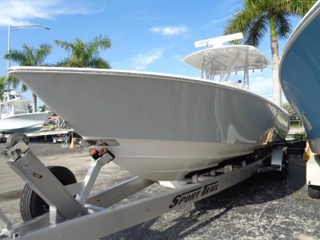  Yacht Photos Pics 2022 Contender 32 ST boat on trailer, parked outdoors with palm trees.