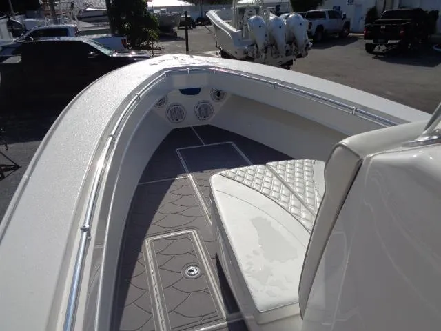  Yacht Photos Pics 2022 Contender 32 ST boat interior with cushioned seating and deck details.