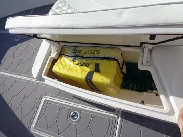  Yacht Photos Pics Storage compartment on 2022 Contender 32 ST boat with life jackets and rope.