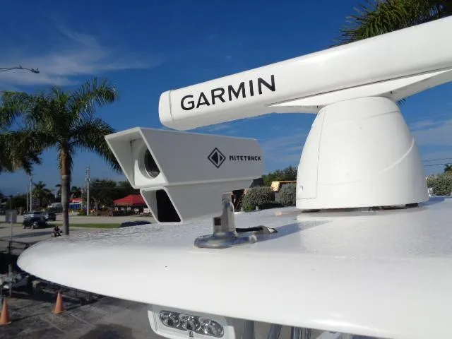  Yacht Photos Pics Garmin radar and Nitetrek camera on 2022 Contender 32 ST boat, with palm trees in background.