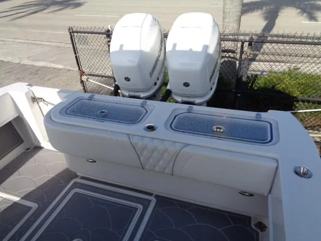  Yacht Photos Pics 2022 Contender 32 ST boat with dual outboard engines and cushioned seating.