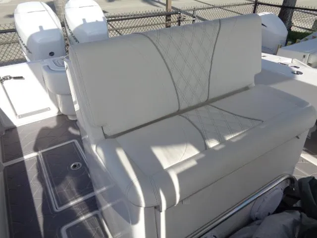  Yacht Photos Pics 2022 Contender 32 ST boat with white cushioned seating and dual outboard motors.