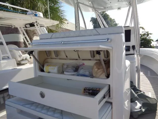  Yacht Photos Pics 2022 Contender 32 ST boat with open storage compartments and seating area.