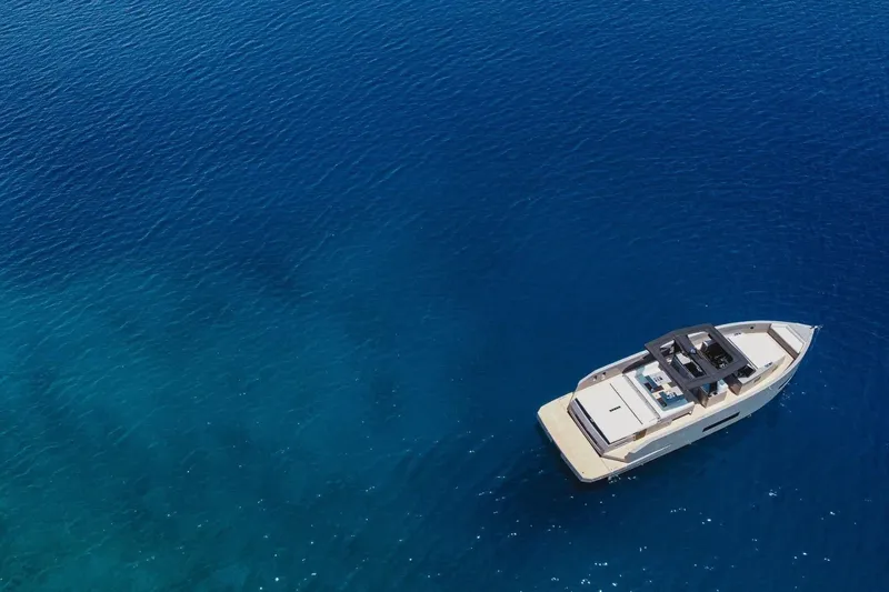  Yacht Photos Pics 2023 De Antonio Yachts D42 Open cruising on clear blue water.