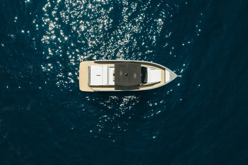  Yacht Photos Pics Aerial view of 2023 De Antonio Yachts D42 Open on sparkling blue water.
