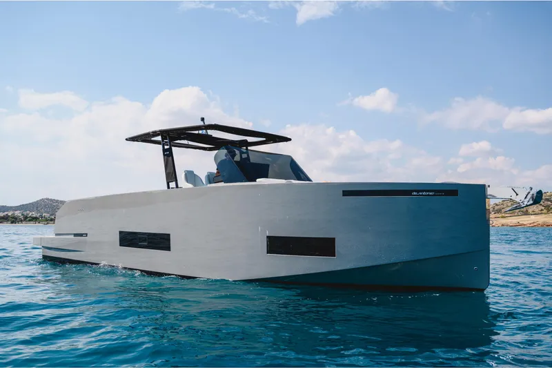  Yacht Photos Pics 2023 De Antonio Yachts D42 Open cruising on clear blue water under a sunny sky.