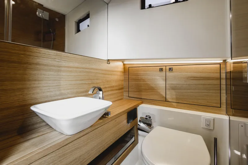  Yacht Photos Pics Luxurious bathroom interior of 2023 De Antonio Yachts D42 Open, featuring modern sink and wood accents.