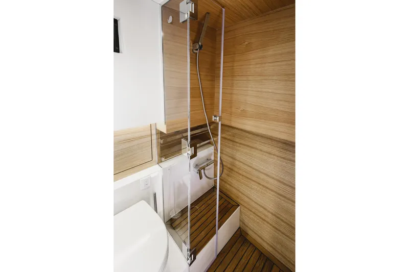  Yacht Photos Pics Luxurious bathroom in 2023 De Antonio Yachts D42 Open, featuring sleek wood paneling and modern fixtures.