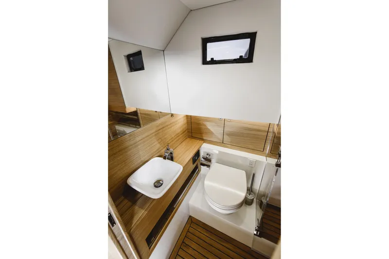  Yacht Photos Pics Modern bathroom interior of 2023 De Antonio Yachts D42 Open, featuring sleek design and wood accents.