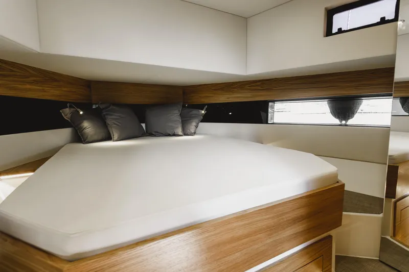  Yacht Photos Pics Luxurious interior cabin of 2023 De Antonio Yachts D42 Open, featuring modern design and comfortable bedding.