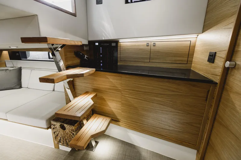  Yacht Photos Pics Luxurious interior of 2023 De Antonio Yachts D42 Open with modern wood finishes and seating.