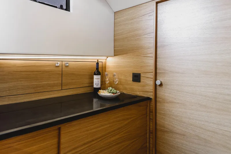  Yacht Photos Pics Luxurious interior of 2023 De Antonio Yachts D42 Open with wine and fruit.