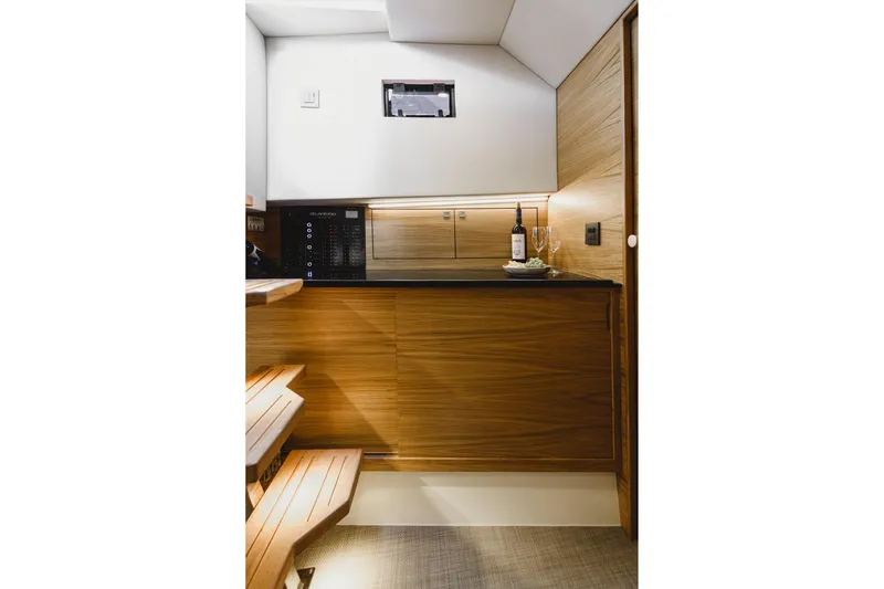  Yacht Photos Pics Luxurious interior of 2023 De Antonio Yachts D42 Open with wooden cabinetry and modern amenities.