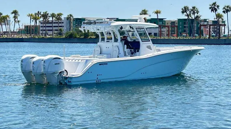 The Reel Commander Yacht Photos Pics 2026 Sea Fox 368 Commander boat on water with palm trees in background.