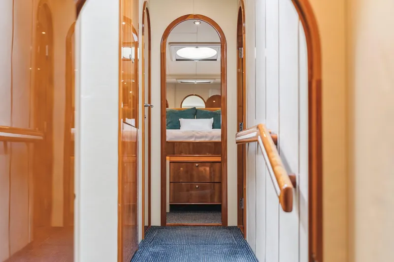 Day To Day Yacht Photos Pics Luxurious hallway inside 2008 Neptunus 62 Flybridge yacht, featuring elegant wood finishes.