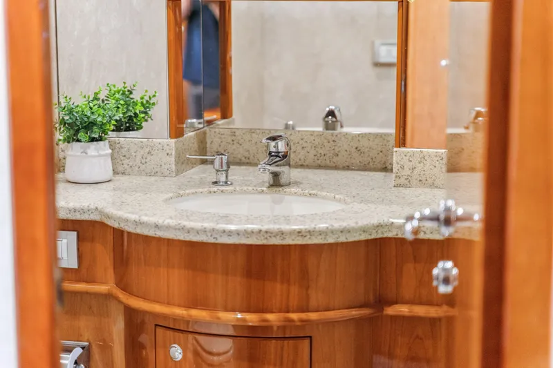 Day To Day Yacht Photos Pics Luxurious bathroom vanity in 2008 Neptunus 62 Flybridge yacht, featuring elegant wood and granite finishes.