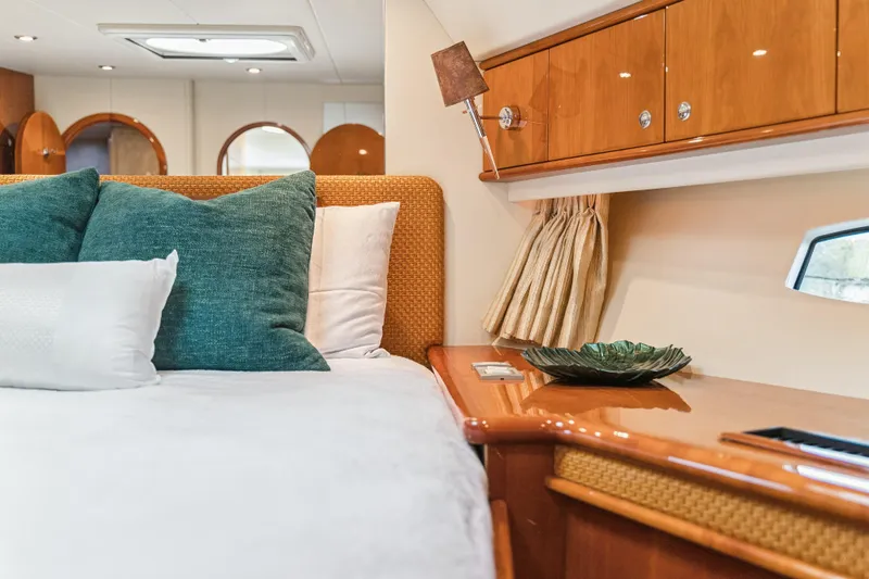 Day To Day Yacht Photos Pics Luxurious bedroom interior of 2008 Neptunus 62 Flybridge yacht with elegant wood finish.