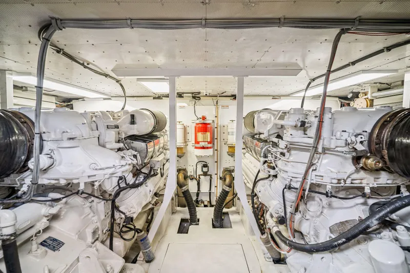 Day To Day Yacht Photos Pics Engine room of 2008 Neptunus 62 Flybridge yacht, featuring dual engines and fire extinguisher.