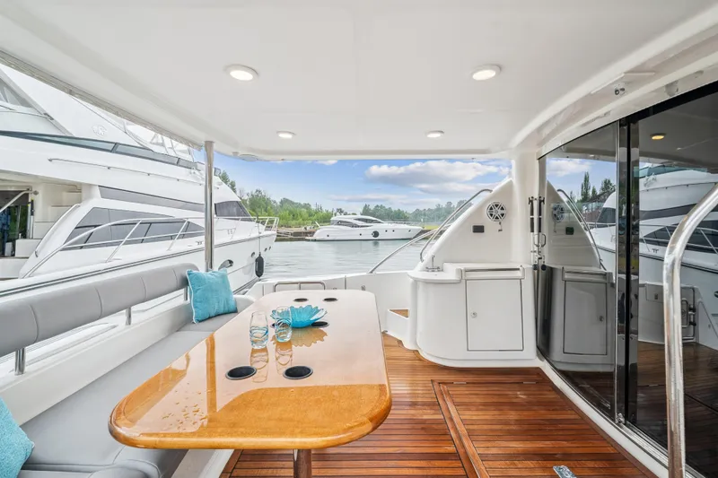 Day To Day Yacht Photos Pics Luxurious 2008 Neptunus 62 Flybridge yacht interior with elegant seating and wooden table.