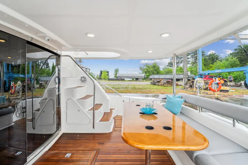 Day To Day Yacht Photos Pics Luxurious 2008 Neptunus 62 Flybridge yacht with elegant outdoor seating and wooden deck.