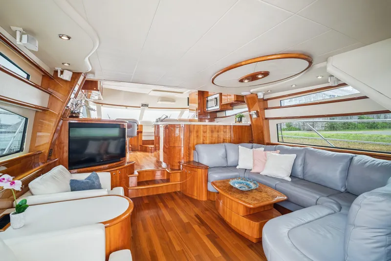Day To Day Yacht Photos Pics Luxurious interior of 2008 Neptunus 62 Flybridge yacht with elegant wood finishes and plush seating.