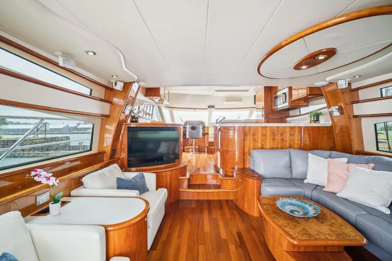 Day To Day Yacht Photos Pics Luxurious interior of 2008 Neptunus 62 Flybridge yacht with elegant wood finishes and modern furnishings.