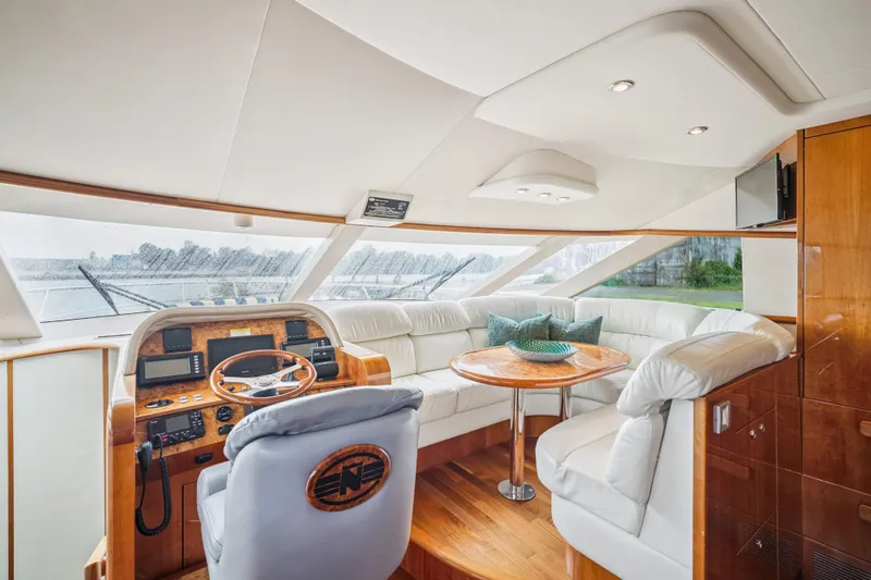 Day To Day Yacht Photos Pics Luxurious 2008 Neptunus 62 Flybridge yacht interior with leather seating and wooden helm.