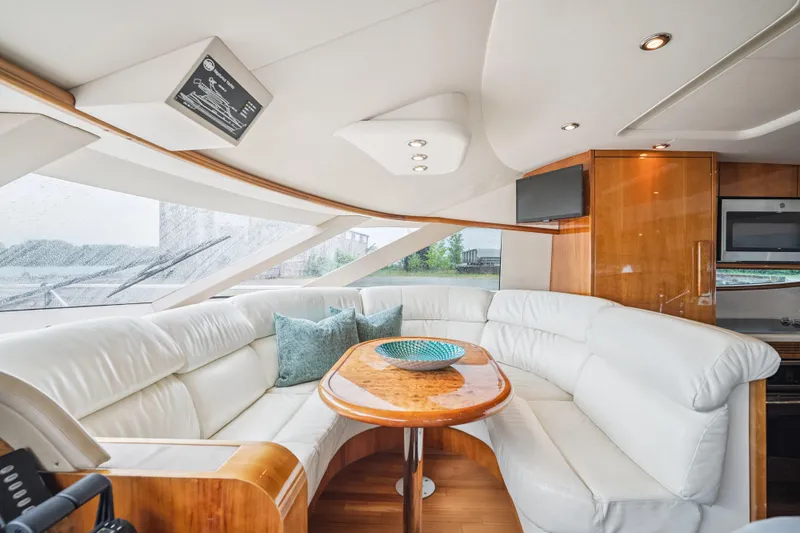 Day To Day Yacht Photos Pics Luxurious interior of 2008 Neptunus 62 Flybridge yacht with white leather seating.