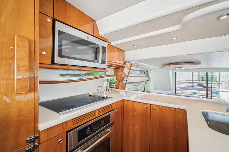 Day To Day Yacht Photos Pics Luxurious kitchen interior of 2008 Neptunus 62 Flybridge yacht with modern appliances.