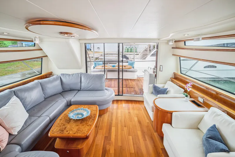 Day To Day Yacht Photos Pics Luxurious interior of 2008 Neptunus 62 Flybridge yacht with elegant seating and wooden accents.