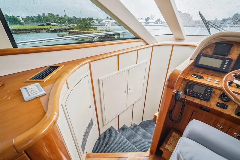 Day To Day Yacht Photos Pics 2008 Neptunus 62 Flybridge yacht interior with helm, stairs, and wood accents.