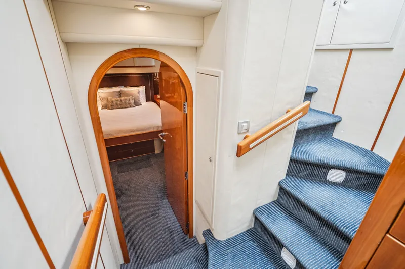 Day To Day Yacht Photos Pics Luxurious interior of 2008 Neptunus 62 Flybridge yacht with elegant staircase and cozy bedroom.