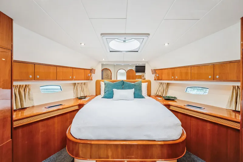 Day To Day Yacht Photos Pics Luxurious 2008 Neptunus 62 Flybridge yacht bedroom with elegant wood finishes and skylight.