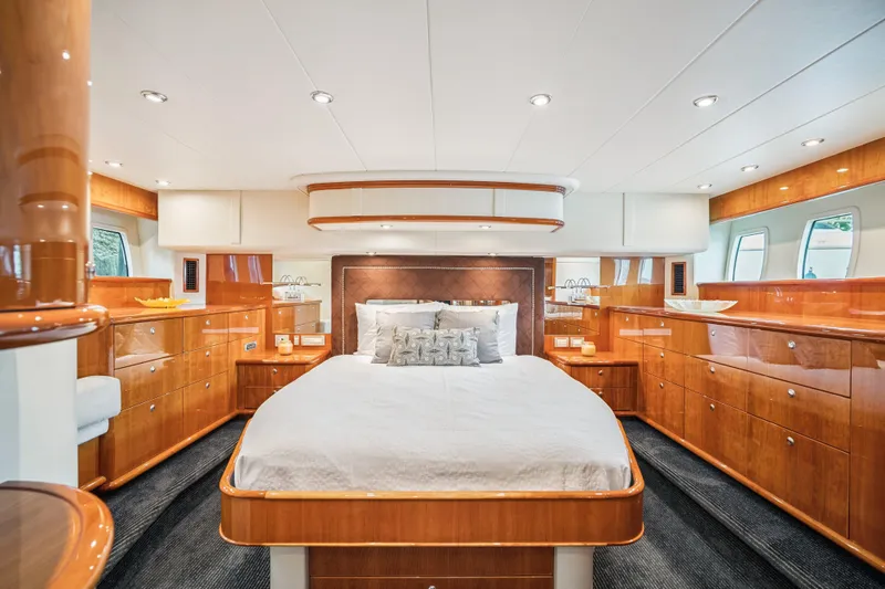 Day To Day Yacht Photos Pics Luxurious 2008 Neptunus 62 Flybridge yacht bedroom with elegant wood finishes and modern lighting.