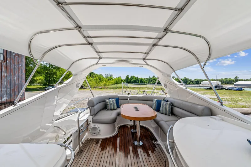 Day To Day Yacht Photos Pics Luxurious 2008 Neptunus 62 Flybridge yacht interior with elegant seating and wooden table.