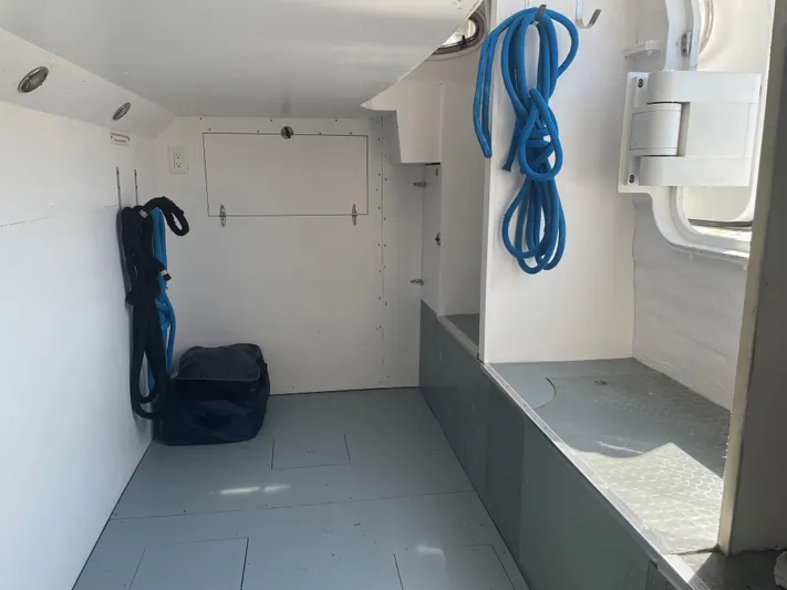 Day To Day Yacht Photos Pics Storage area inside 2008 Neptunus 62 Flybridge yacht with ropes and equipment.