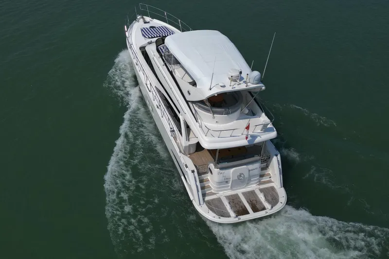 Day To Day Yacht Photos Pics 2008 Neptunus 62 Flybridge yacht cruising on open water, aerial view.