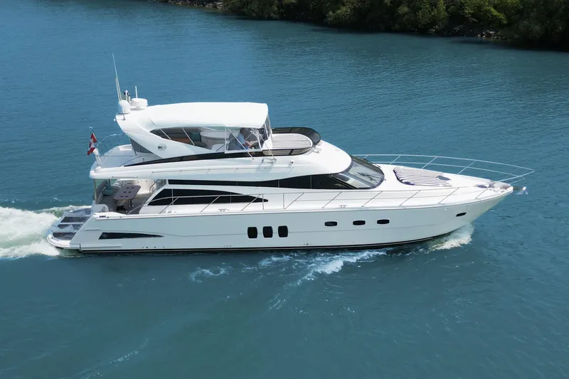 Day To Day Yacht Photos Pics 2008 Neptunus 62 Flybridge yacht cruising on blue water.