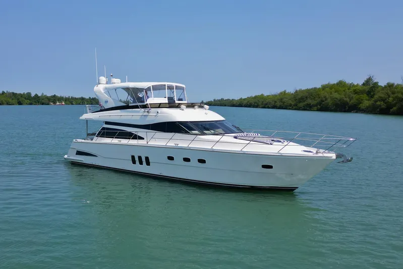Day To Day Yacht Photos Pics 2008 Neptunus 62 Flybridge yacht cruising on calm waters under clear blue sky.
