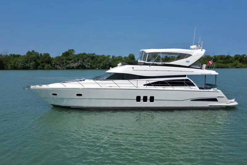 Day To Day Yacht Photos Pics 2008 Neptunus 62 Flybridge yacht on calm water, clear sky background.