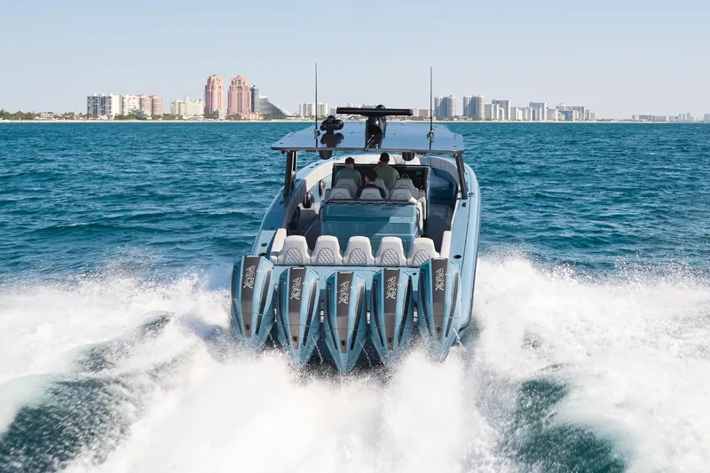  Yacht Photos Pics 2023 Midnight Express 43' Open boat cruising on ocean with city skyline in background.