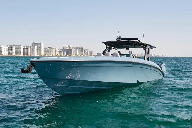  Yacht Photos Pics 2023 Midnight Express 43' Open boat on clear blue water near city skyline.