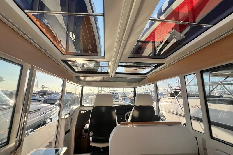  Yacht Photos Pics Interior view of 2025 Nimbus C11 boat with panoramic windows and modern seating.