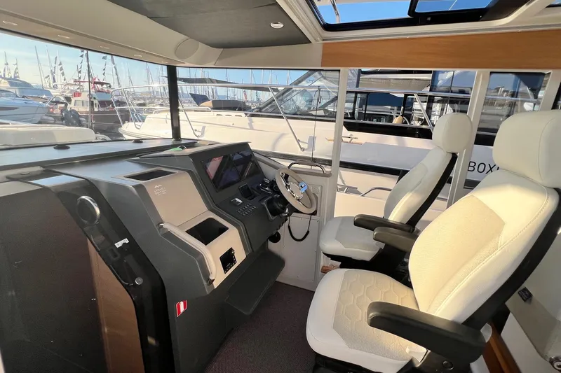  Yacht Photos Pics Interior of 2025 Nimbus C11 boat with modern dashboard and comfortable seating.