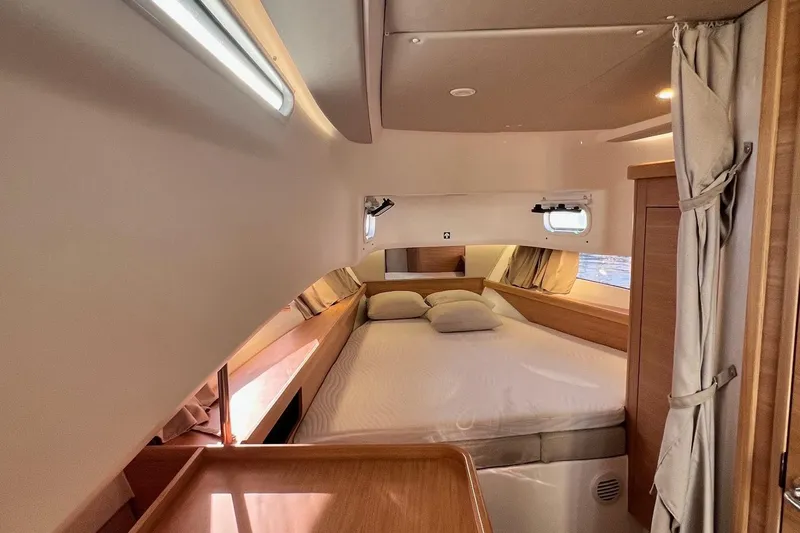  Yacht Photos Pics Luxurious interior cabin of 2025 Nimbus C11 yacht with cozy bedding.