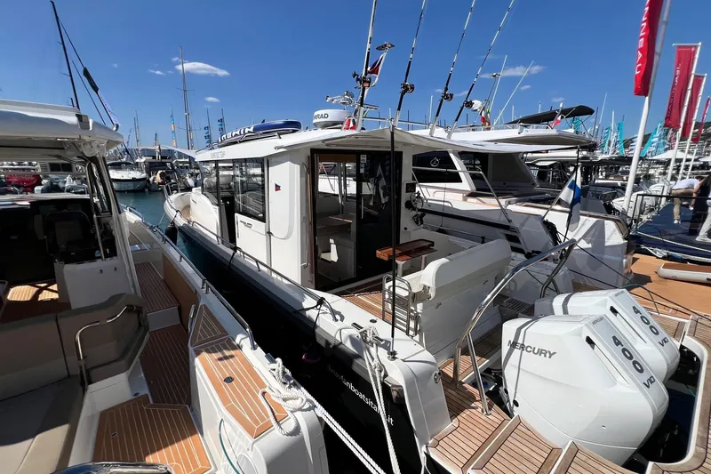  Yacht Photos Pics 2025 Nimbus C11 boat at marina, featuring Mercury engines and sleek design.