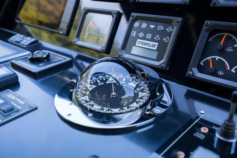 Queen Karina Yacht Photos Pics Control panel of a 2000 Cheoy Lee 92 ft yacht with compass and gauges.