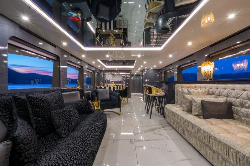Queen Karina Yacht Photos Pics Luxurious interior of a 2000 Cheoy Lee 92 ft yacht with elegant seating and ambient lighting.