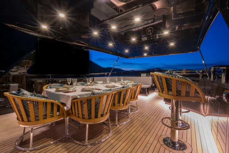Queen Karina Yacht Photos Pics Luxurious dining area on a 2000 Cheoy Lee 92 ft yacht at sunset.
